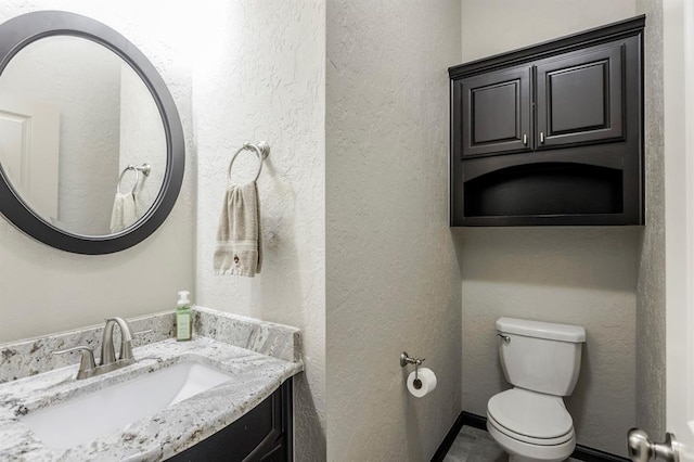 2241 W Mickey Dr, Mustang, OK 73064 - half bathroom with a textured wall, vanity, and toilet