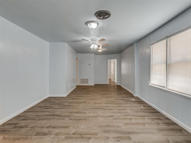 unfurnished room with visible vents, baseboards, light wood-style floors, and a ceiling fan