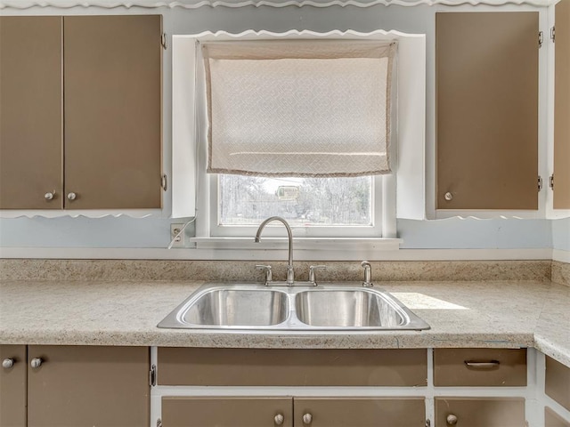 kitchen featuring light countertops and a sink