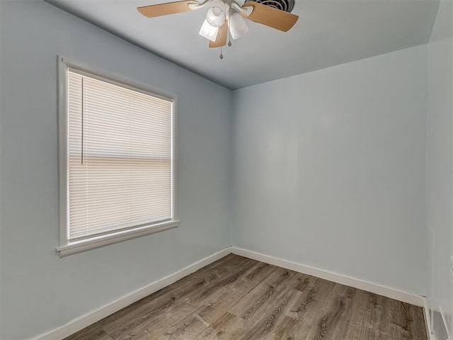 unfurnished room featuring ceiling fan, baseboards, and wood finished floors