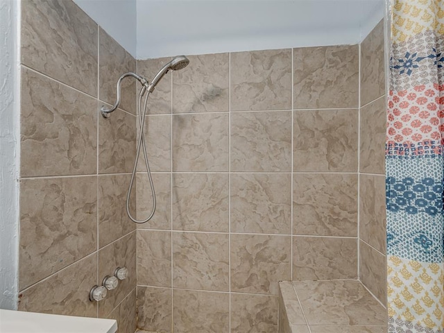 bathroom with tiled shower