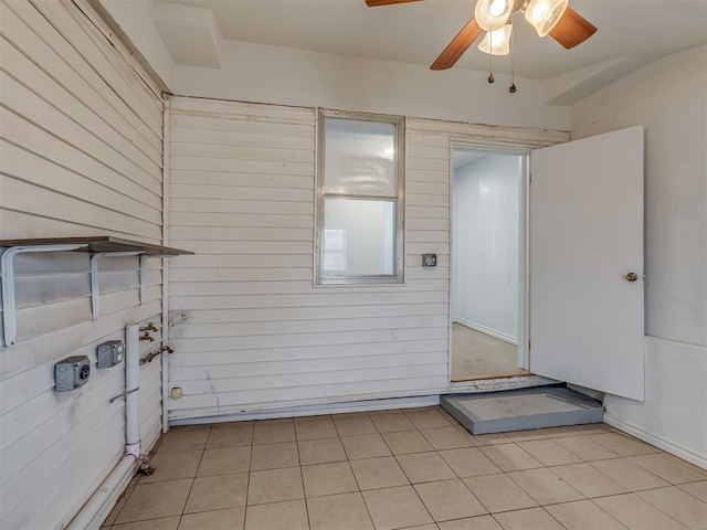 interior space with light tile patterned flooring and ceiling fan