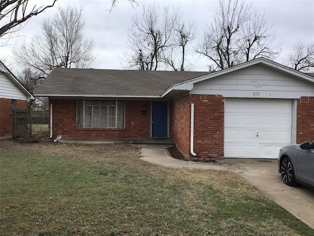 ranch-style house featuring brick siding, an attached garage, concrete driveway, and a front lawn