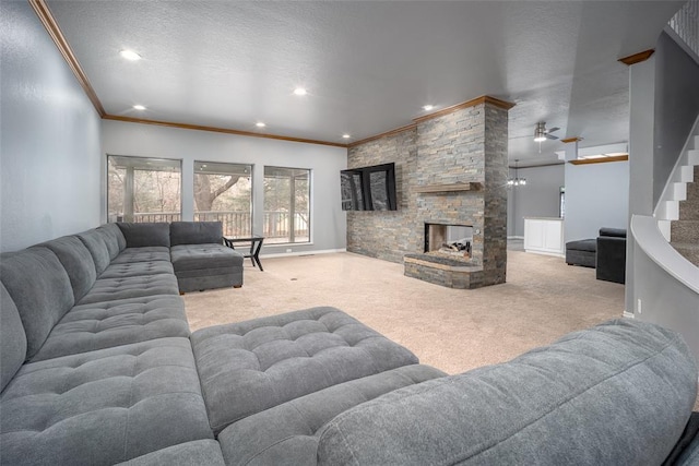 living area featuring carpet, ornamental molding, recessed lighting, a fireplace, and a textured ceiling