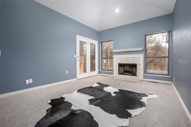 carpeted living area with visible vents, baseboards, high vaulted ceiling, and a fireplace