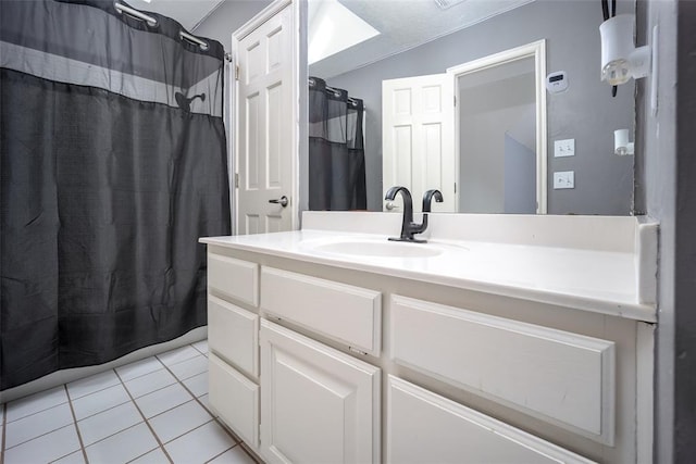 bathroom featuring tile patterned flooring, vanity, and a shower with curtain