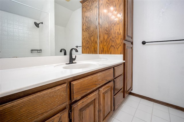 full bath featuring a shower, baseboards, lofted ceiling, and vanity