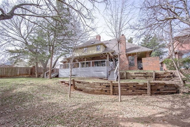 exterior space with a chimney and fence