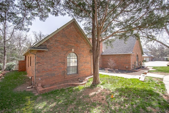 view of property exterior featuring brick siding