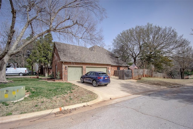 view of side of home with brick siding, fence, concrete driveway, roof with shingles, and an attached garage