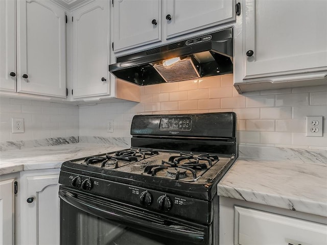 kitchen featuring under cabinet range hood, decorative backsplash, white cabinets, and gas stove