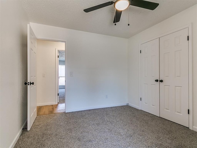 unfurnished bedroom with a closet, carpet flooring, and a textured ceiling