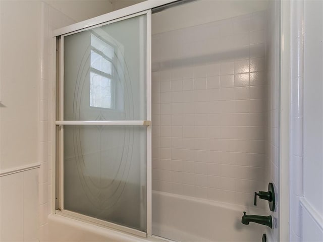 full bath featuring combined bath / shower with glass door