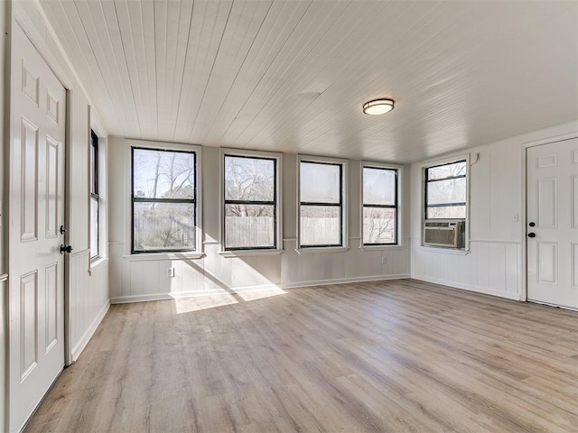 interior space featuring light wood-type flooring, wood ceiling, and cooling unit