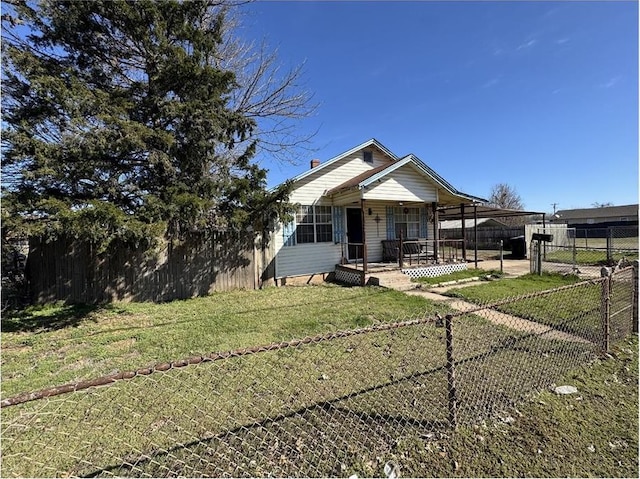 501 SE 15th St, Oklahoma City, OK 73129 - bungalow-style house with a porch, a fenced backyard, and a front lawn