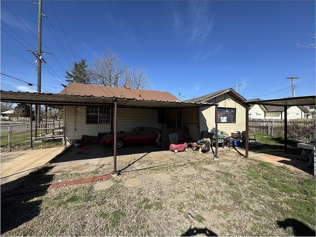 501 SE 15th St, Oklahoma City, OK 73129 - rear view of house featuring fence and a carport