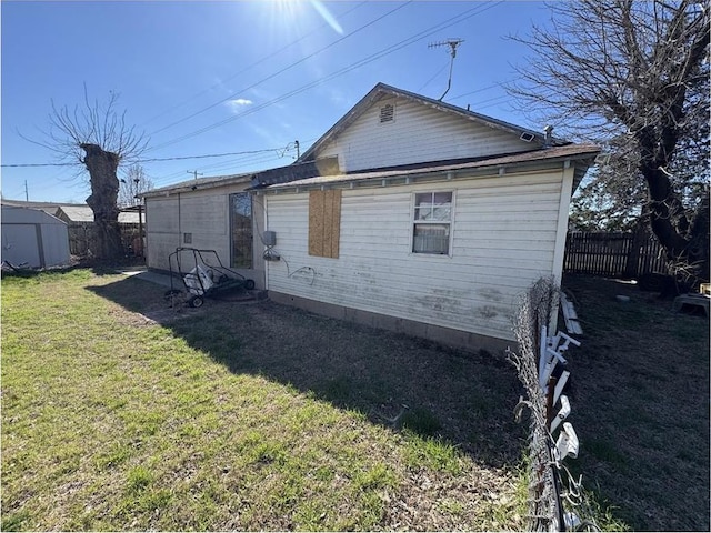 501 SE 15th St, Oklahoma City, OK 73129 - back of property featuring an outbuilding, a lawn, a shed, and a fenced backyard