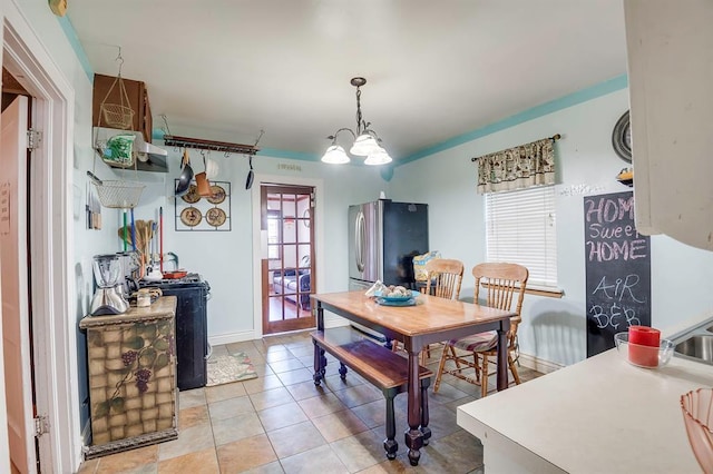 501 SE 15th St, Oklahoma City, OK 73129 - dining area with a chandelier, baseboards, and light tile patterned floors