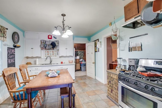 501 SE 15th St, Oklahoma City, OK 73129 - kitchen featuring white cabinets, light countertops, a sink, and stainless steel gas range oven