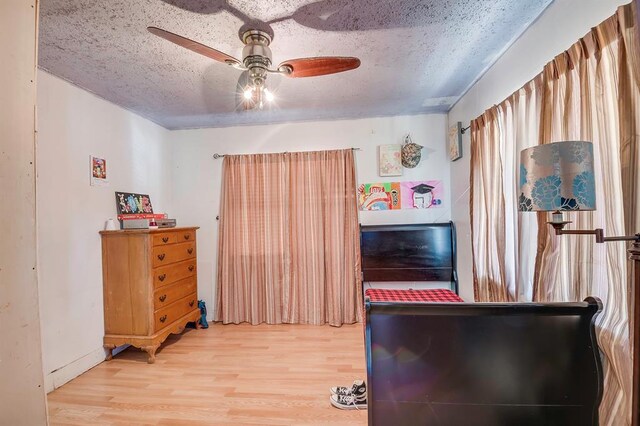 501 SE 15th St, Oklahoma City, OK 73129 - bedroom with wood finished floors, a textured ceiling, and ceiling fan