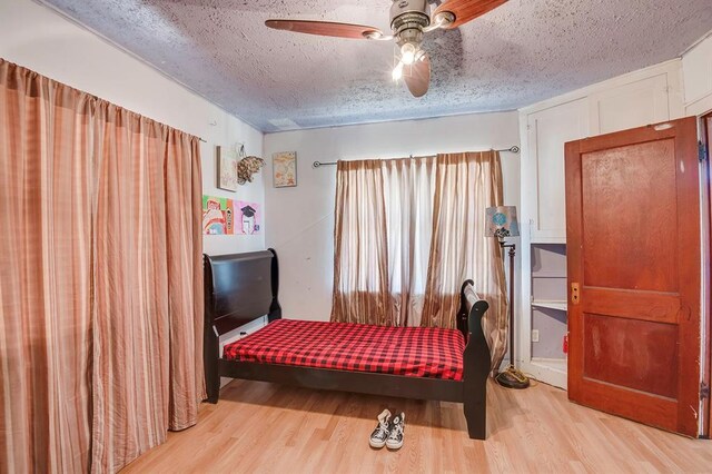 501 SE 15th St, Oklahoma City, OK 73129 - bedroom with ceiling fan, a textured ceiling, and light wood-type flooring