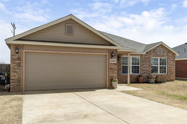 ranch-style house with brick siding, an attached garage, driveway, and a shingled roof