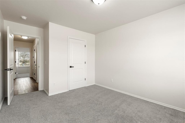 unfurnished bedroom featuring baseboards and carpet