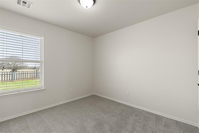 unfurnished room featuring baseboards, visible vents, and carpet floors