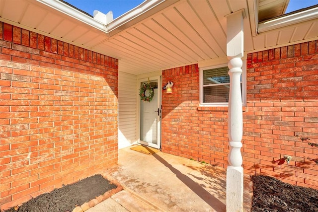 property entrance featuring brick siding