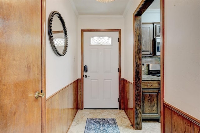 doorway with light tile patterned flooring, wainscoting, wood walls, and ornamental molding