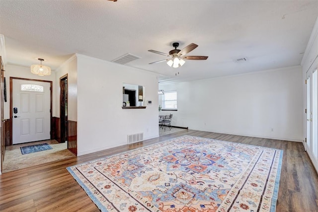 interior space featuring visible vents, a ceiling fan, and wood finished floors