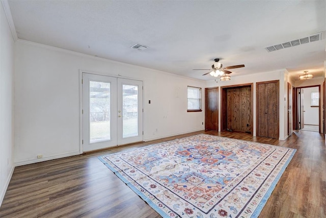 interior space with visible vents, baseboards, and wood finished floors