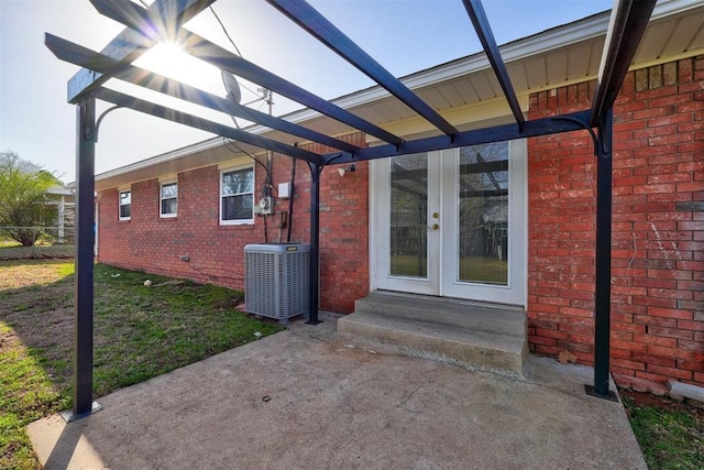 view of patio featuring central AC unit, entry steps, and french doors