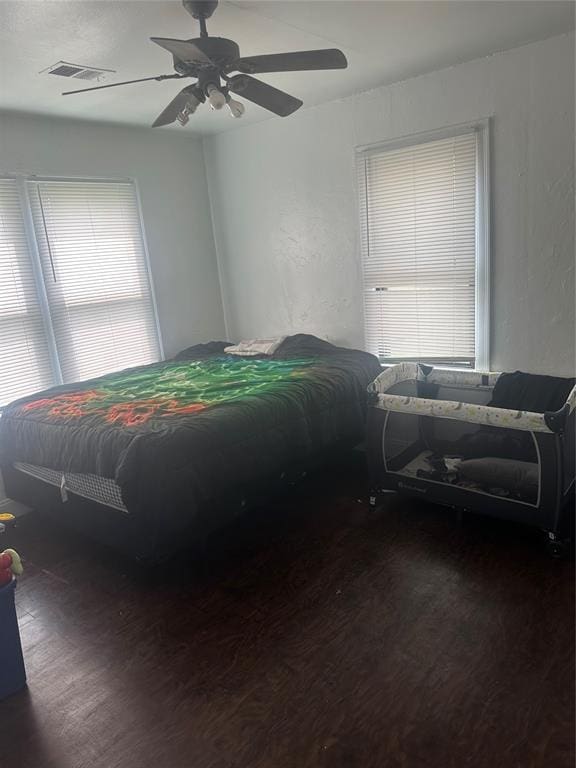118 NE 2nd St, Moore, OK 73160 - bedroom with wood finished floors and a ceiling fan
