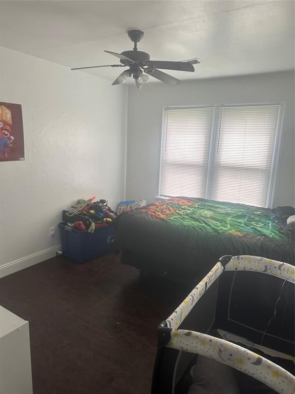 118 NE 2nd St, Moore, OK 73160 - bedroom featuring baseboards and a ceiling fan