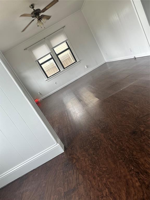 118 NE 2nd St, Moore, OK 73160 - unfurnished room with wood finished floors, ceiling fan, and baseboards