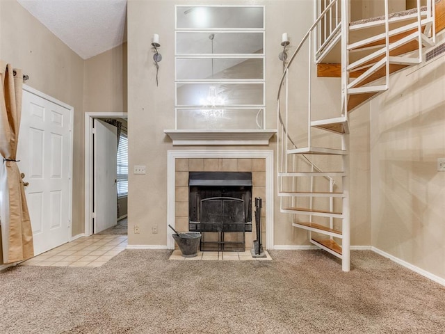 unfurnished living room with a fireplace, carpet, and baseboards