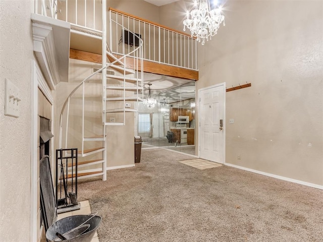 interior space with stairs, baseboards, a notable chandelier, and carpet flooring