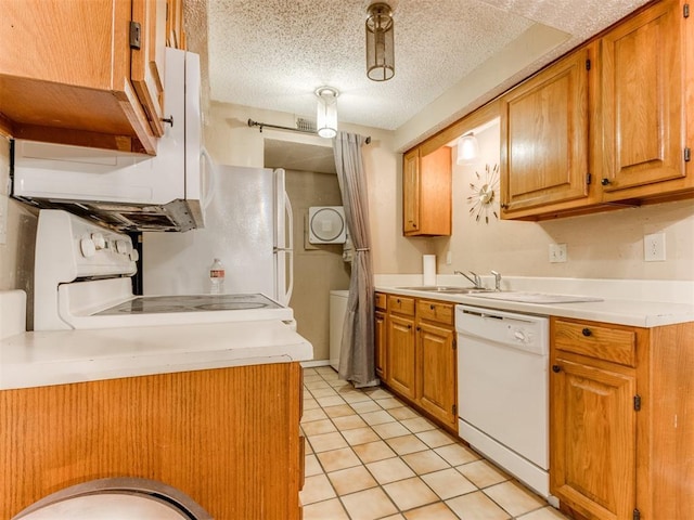 kitchen with light countertops, range, white dishwasher, a textured ceiling, and a sink