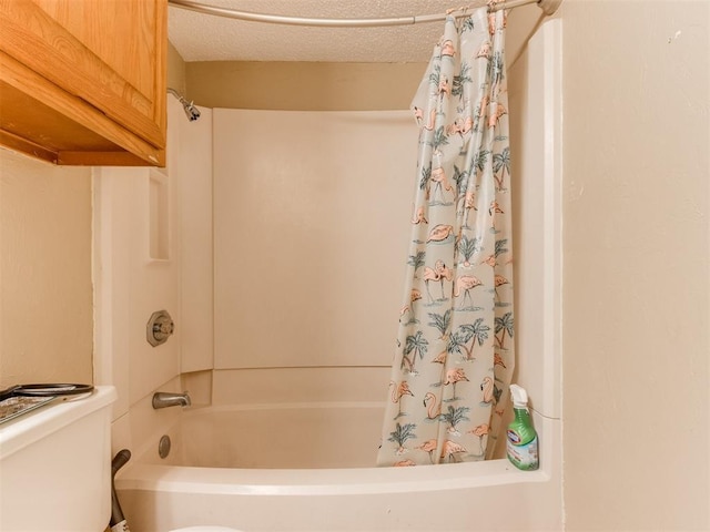 full bath with toilet, a textured ceiling, and shower / tub combo