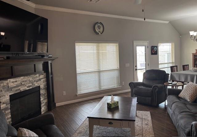living room featuring dark wood finished floors, baseboards, and crown molding