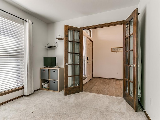 entryway featuring carpet flooring, french doors, and baseboards