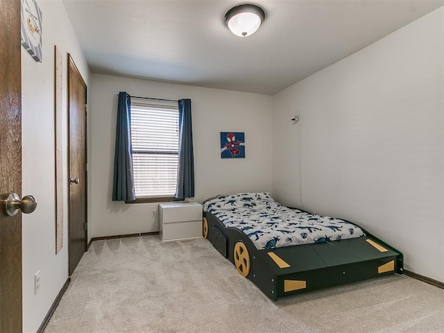 carpeted bedroom featuring baseboards