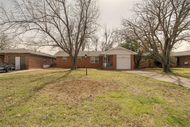 single story home with a front lawn, brick siding, concrete driveway, and an attached garage