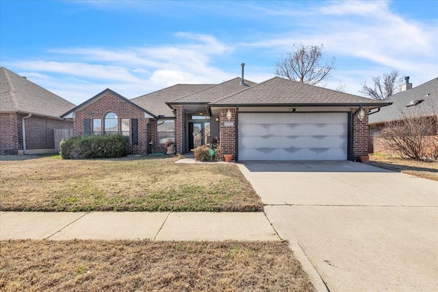 view of front of home with a front yard, an attached garage, brick siding, and concrete driveway