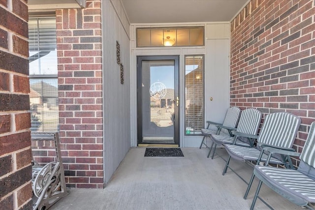 entrance to property featuring brick siding