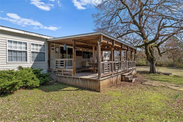 wooden deck featuring a lawn