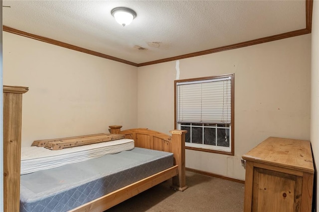 bedroom featuring carpet flooring, a textured ceiling, baseboards, and ornamental molding