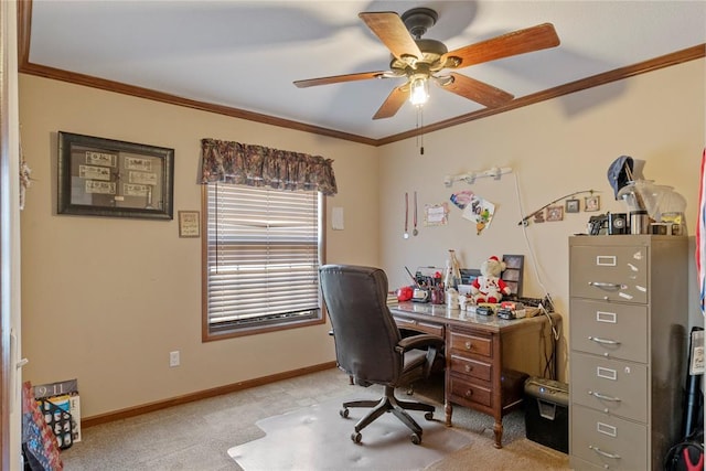 home office with baseboards, a ceiling fan, light carpet, and crown molding
