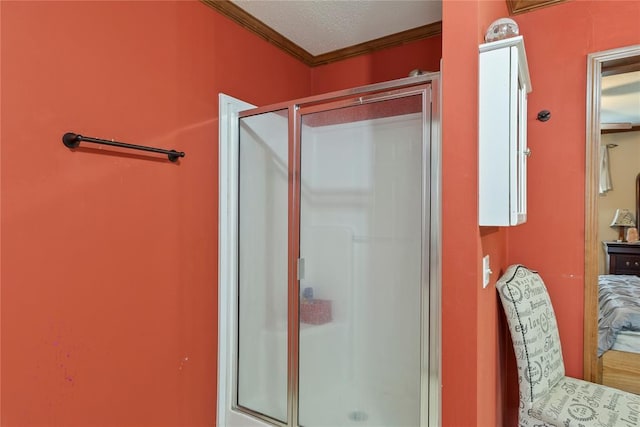 full bathroom with a shower stall and crown molding